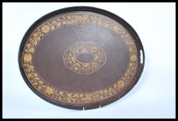 A 19th century Victorian oval toleware tray with gilded decoration. The gallery edge with open