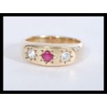 A hallmarked 9ct gold ring set with a central ruby