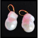 A large pair of baroque pearl drop earrings having