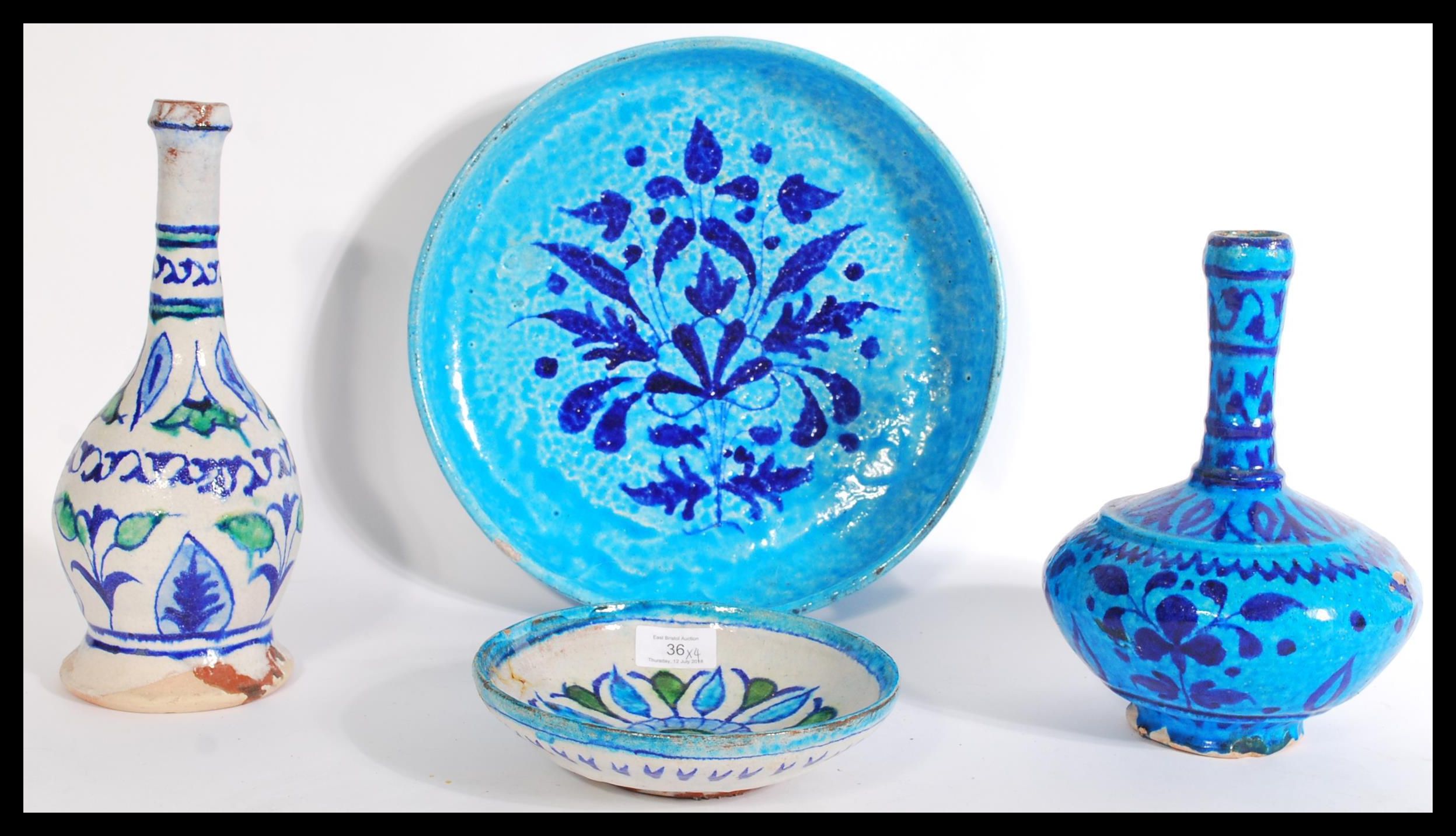 A collection of four Persian / Islamic glazed pott