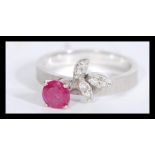 A 14ct white gold ruby and diamond ring having a c