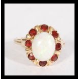 A 14ct gold opal and garnet cluster ring set with