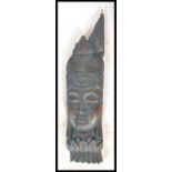 A 20th Century painted Balinese carved wooden deit