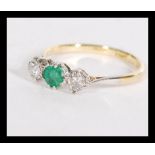 An 18ct gold and platinum set three stone emerald