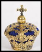 A brass pin cushion in the form of a crown having