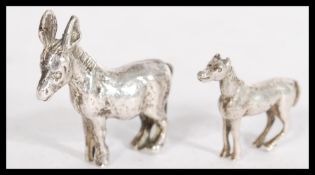A silver miniature model figurine of a horse along