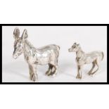 A silver miniature model figurine of a horse along