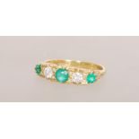 An 18ct gold emerald and diamond five stone ring h