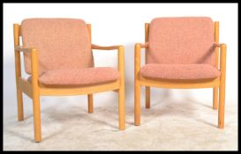 A pair of 20th century Ercol staff chairs. Light b