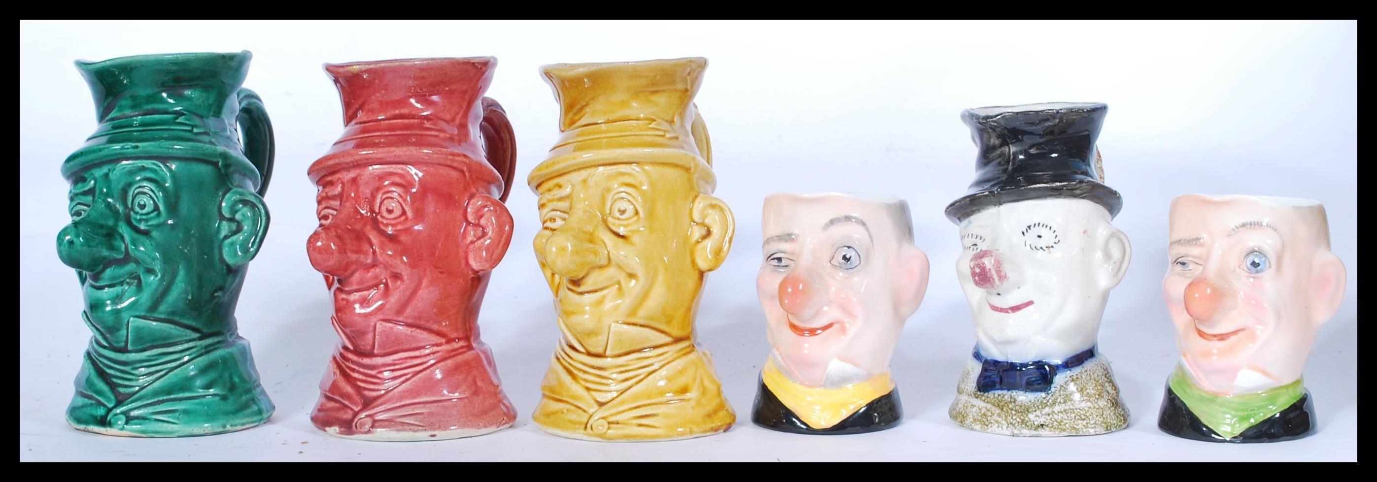 A collection of six varies ceramic character Jugs