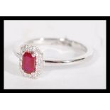 An 18ct white gold ruby and diamond ring having a