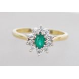 An 18ct gold diamond and emerald diamond ring havi