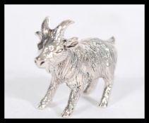 A sterling silver figurine of a goat modelled in a