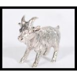 A sterling silver figurine of a goat modelled in a