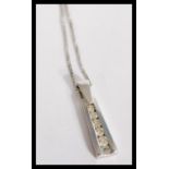 A hallmarked 9ct white gold and diamond pendant ne