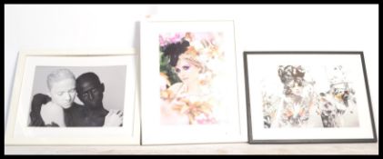 A group of three large framed photographic prints