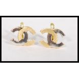 A pair of 18ct gold earrings having an entwined CC