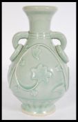 A Chinese Celadon baluster vase raised on circular