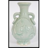 A Chinese Celadon baluster vase raised on circular