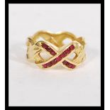 A hallmarked 18ct gold and ruby band ring fashione