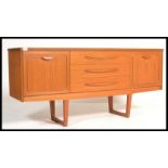 A vintage mid century teak veneer sideboard with 3