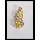 A hallmarked 9ct gold peridot and white stone set