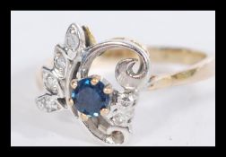 A 14ct gold diamond and sapphire ring having a cen