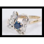 A 14ct gold diamond and sapphire ring having a cen