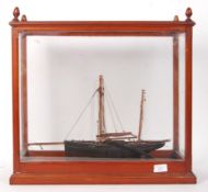 ANTIQUE SCRATCH BUILT FISHING BOAT IN GLAZED CABINET