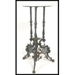 A 19th century cast iron table raised on quadruped