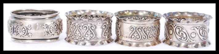 A collection of 4 silver hallmarked napkin rings t