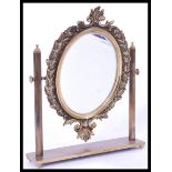 A 19th century brass mirror raised on plinth base