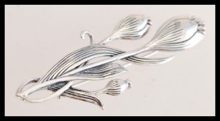 A contemporary silver Art Deco style flower brooch