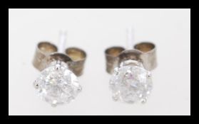 A pair of 14ct white gold diamond stud earrings of