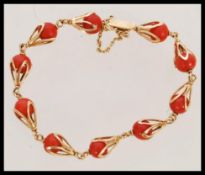 A French 18ct gold and corral bracelet having orna