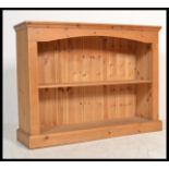 A 20th Century pine open bookcase fitted with shel