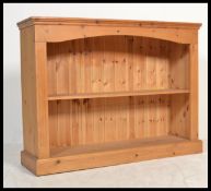 A 20th Century pine open bookcase fitted with shel