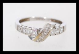 A hallmarked 9ct white gold ring set with princess