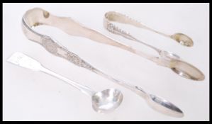 A large pair silver hallmarked sugar tongs, marked