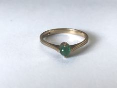 A hallmarked 9ct gold and emerald ring set with an