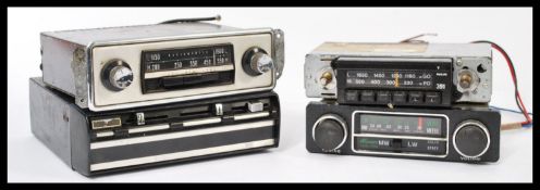 A group of four vintage car radio receivers to inc