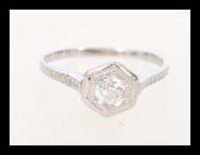 A 14 carat hexagon diamond ring featuring a built