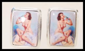 A set of sterling silver cuff links with enamel pa