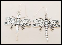 A contemporary pair of silver dragon fly earrings