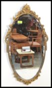 A vintage mid century antique style wall mirror having central beveled panel with gilt scrolled
