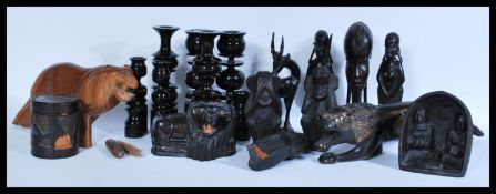 A collection of African ornaments to include a set of eight turned candle sticks with fiscal