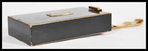 A vintage retro mid 20th Park Lane century brass compact with black enameled panels having a