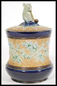 George Tinworth for Doulton Lambeth, a late 19th century lidded stoneware tobacco jar, decorated