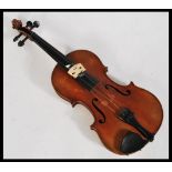 A vintage 20th century violin musical instrument having shaped hollow body with ebonised tuning