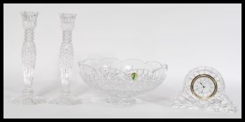A selection of Waterford crystal to include a cut glass punch bowl, a mantle clock with roman